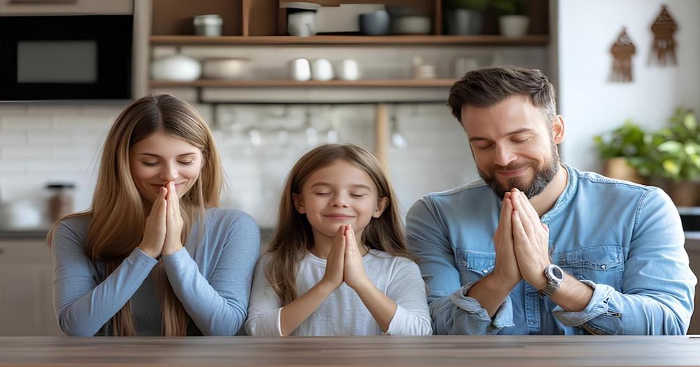 Image of a family sitting and praying together