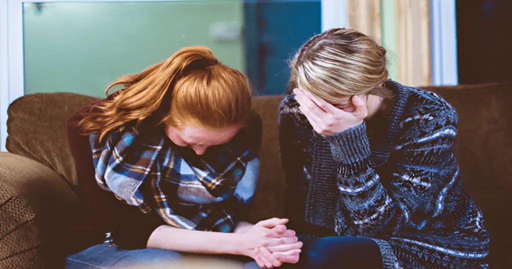 Image of two woman praying together